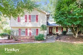 Lawrenceville house for rent - a white house with red shutters and a lawn and trees