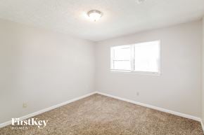 Lawrenceville house for rent - a bedroom with white walls and carpet and a window