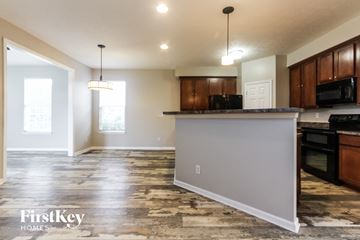 Greenwood house for rent - an open kitchen and living room with a granite counter top
