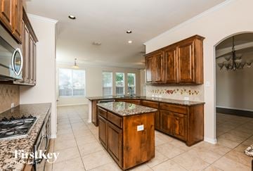 Fort Worth house for rent - A kitchen with wooden cabinets and a granite countertop.