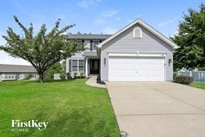 O'fallon house for rent - a white house with a driveway and a white garage door