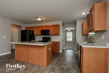 O'fallon house for rent - a kitchen with wooden cabinets and a white counter top