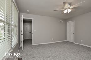 O'fallon house for rent - a bedroom with a ceiling fan and a window