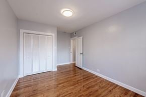 Chicago apartment for rent - an empty living room with wood flooring and a closet