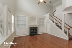 Charlotte house for rent - A living room with a fireplace and a staircase.