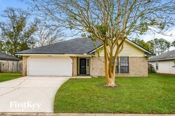 Jacksonville house for rent - a small brick house with a tree in the front