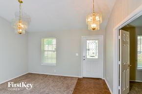 San Antonio house for rent - A room with a carpeted floor and two hanging lights.
