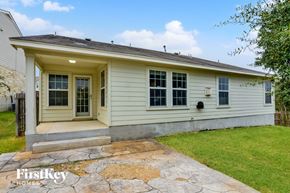 San Antonio house for rent - A small house with a porch and a stone walkway in front.