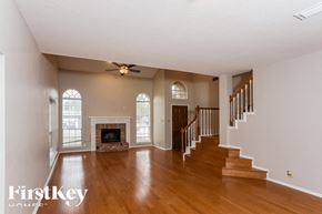 San Antonio house for rent - A spacious living room with a fireplace and stairs leading to another room.