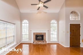San Antonio house for rent - A large, empty room with a fireplace and a ceiling fan.