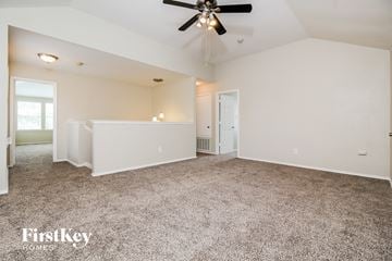 Mckinney house for rent - a spacious living room with carpet and a ceiling fan