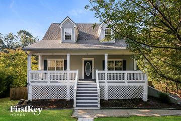 Gainesville house for rent - a white house with a white fence and a black door