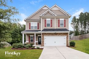Clayton house for rent - a house with a white garage door in front of it