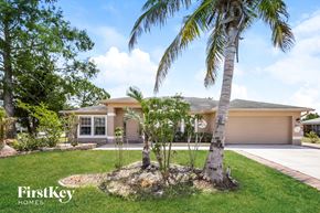 Lehigh Acres house for rent - a house with palm trees in front of it