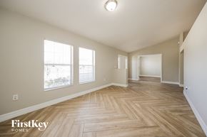 Lehigh Acres house for rent - a spacious living room and dining room with hardwood flooring