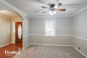 Stockbridge house for rent - a living room with a ceiling fan and a window and a door