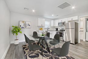 Scottsdale apartment for rent - a dining room with a table and chairs and a kitchen with stainless steel appliances