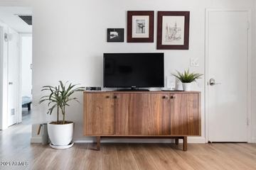 Phoenix apartment for rent - a living room with a television on top of a wooden cabinet