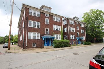 Pittsburgh apartment for rent - A red brick building with blue doors and windows.