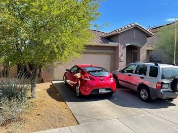 New River house for rent - two cars parked in a driveway in front of a house