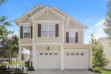 Charlotte house for rent - the front of a white house with two garage doors