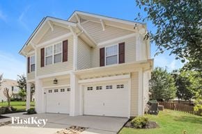 Charlotte house for rent - a white two story house with white garage doors