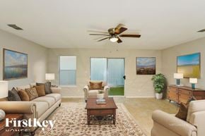 San Antonio house for rent - A living room with a couch, a coffee table, and a ceiling fan.