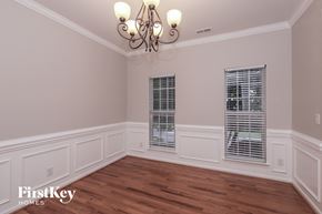 Indian Trail house for rent - the dining room of a home with wood flooring and a chandelier