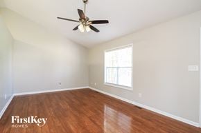 Winston Salem house for rent - A room with a ceiling fan and wooden flooring.