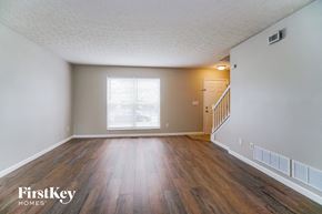 Galloway house for rent - A room with wooden floors and a window with blinds.