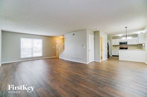 Galloway house for rent - A spacious living room with wooden floors and a kitchen area in the background.