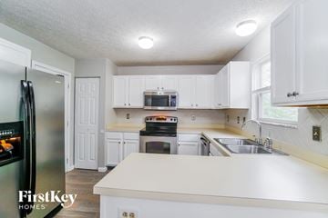 Galloway house for rent - A kitchen with white cabinets and a refrigerator.