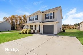 Benson house for rent - a white house with a garage and a driveway