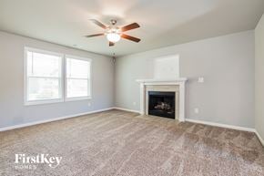 Benson house for rent - the living room with fireplace and ceiling fan