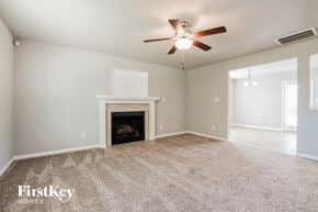 Benson house for rent - the living room with fireplace and ceiling fan
