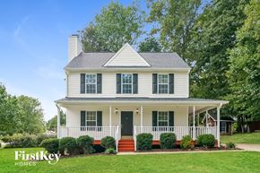 Holly Springs house for rent - a white house with a porch and a green lawn