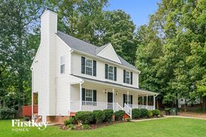 Holly Springs house for rent - a white house with green trees and a lawn