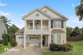 Charlotte house for rent - a white house with a porch and a driveway