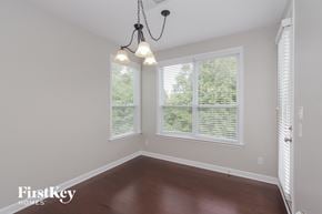 Charlotte house for rent - an empty room with three windows and a chandelier