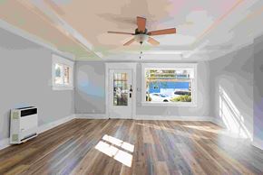 Long Beach apartment for rent - an empty living room with white walls and a ceiling fan