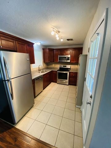 Lafayette house for rent - A kitchen with a refrigerator, microwave, oven, and sink.