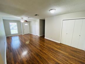 Lafayette house for rent - A room with wood flooring and white walls.