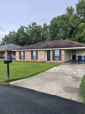Lafayette house for rent - A small brick house with a blue mailbox on the left.