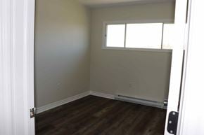 Wolfville apartment for rent - an empty room with a window and wooden floors