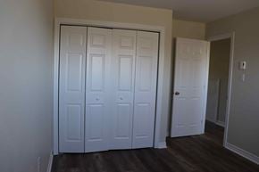 Wolfville apartment for rent - a bedroom with two closets and a door to a hallway