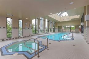 Burnaby apartment for rent - A large indoor swimming pool with a skylight above it.