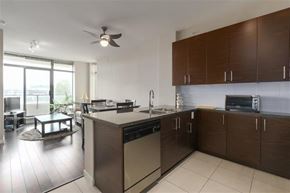 Burnaby apartment for rent - A modern kitchen with a large island and stainless steel appliances.