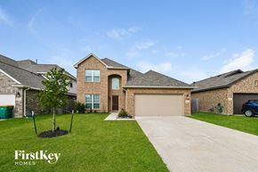 Baytown house for rent - a large brick house with a garage and a driveway