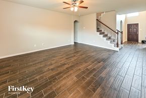 Baytown house for rent - an empty living room with wood flooring and a staircase