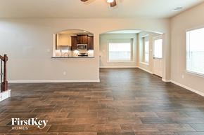 Baytown house for rent - the living room and kitchen of a new home with a tile floor